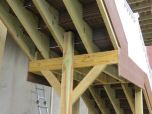 a wooden beam and post under a stair landing