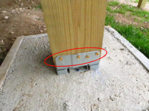 a metal bracket on a wood post